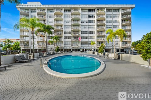 A large building with a pool in front.