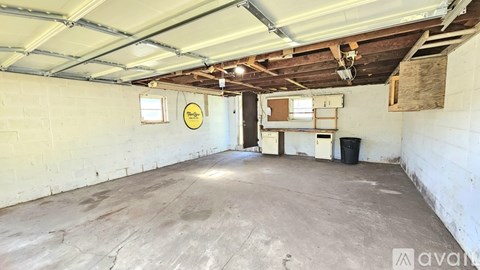 A spacious garage with a concrete floor and white walls.