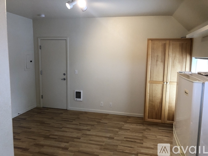 A room with a wooden floor and a white door.