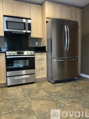 A kitchen with a stainless steel refrigerator and oven.