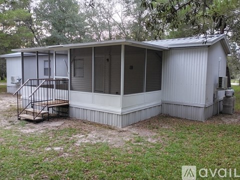 A metal house with a porch and a covered entrance.