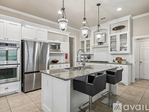 A kitchen with granite countertops and stainless steel appliances.