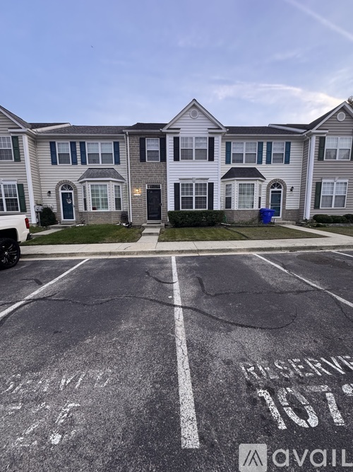 A parking lot with the word "RESERVE" and the number "107" painted on the pavement.