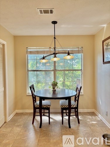 A dining room with a table and chairs.