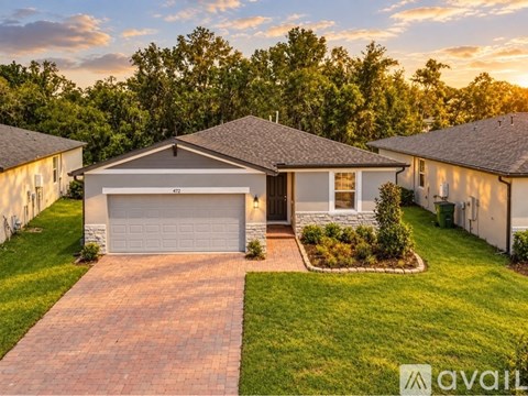 A house with a garage is for sale.