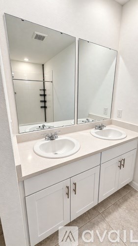 A bathroom with a vanity and a large mirror.