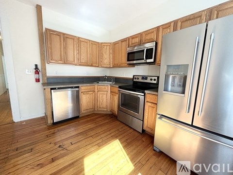 A kitchen with wooden cabinets and stainless steel appliances.