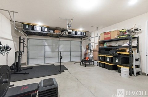 A garage with a gym setup and storage shelves.