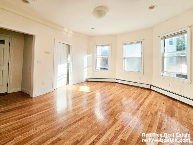 A room with wooden floors and white walls.