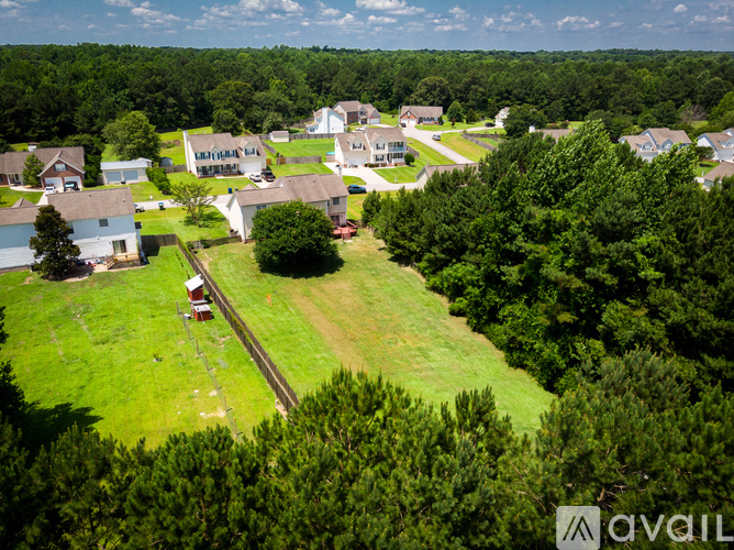A bird's eye view of a residential area with houses and trees.