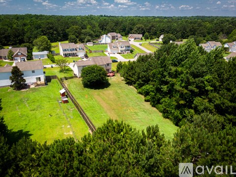 A bird's eye view of a residential area with houses and trees.