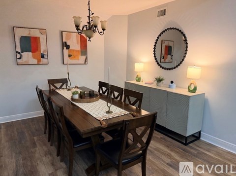 A dining room with a wooden table and chairs.