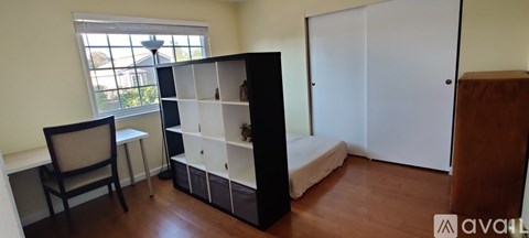 A room with a bed, a chair, and a desk.