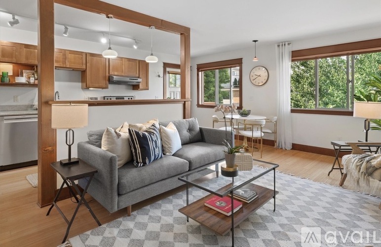 A modern living room with a grey sofa and a coffee table.