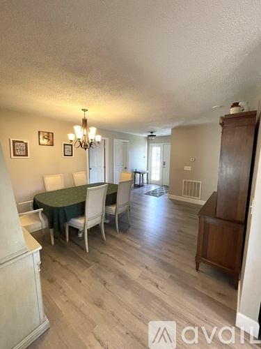 A dining room with a table set for four.