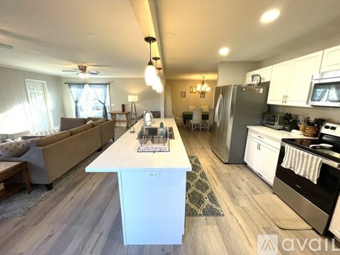A kitchen with a white island in the middle of the room.