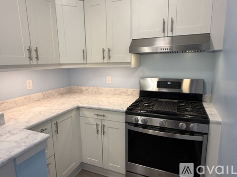 A kitchen with a stove and cabinets.