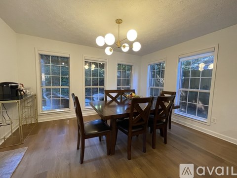 A dining room with a table and chairs.