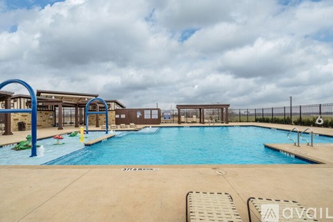 A large outdoor swimming pool with a diving board and lane markers.