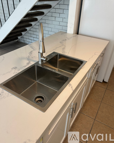 A kitchen sink with a faucet and a countertop.
