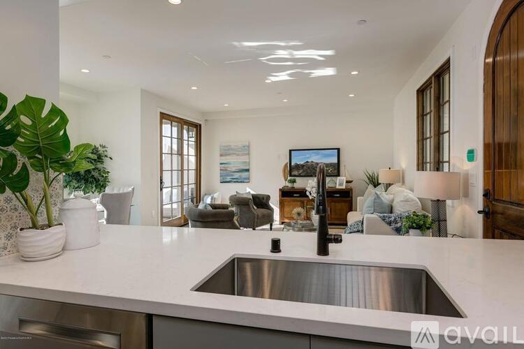 A modern kitchen with a stainless steel sink and a large island.