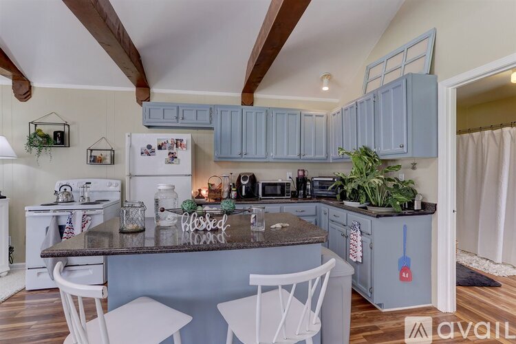 A kitchen with a white fridge and a counter with a chalkboard that says "blessed".