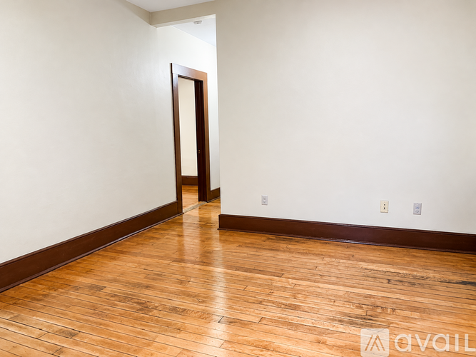 A room with a wooden floor and a door.