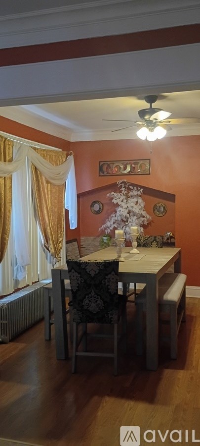 A dining room with a table and chairs.