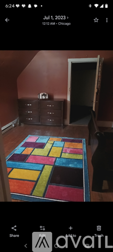 A room with a brown wall and a colorful rug on the floor.