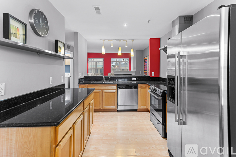 A modern kitchen with wooden cabinets and stainless steel appliances.