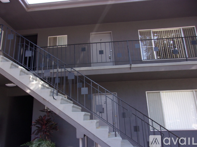 A staircase with a metal railing and a sign that says "available" on the wall.