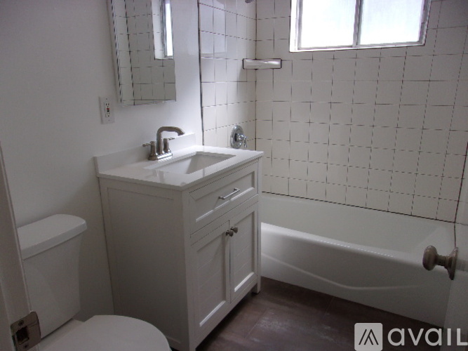 A white bathroom with a sink, toilet, and bathtub.