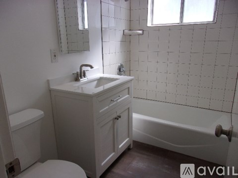 A white bathroom with a sink, toilet, and bathtub.