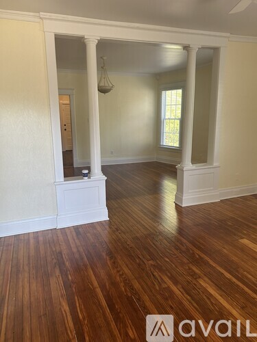 A room with wooden floors and white walls.