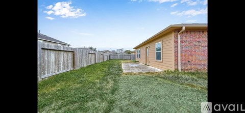 A grassy area in front of a row of houses with a sign that says "available".