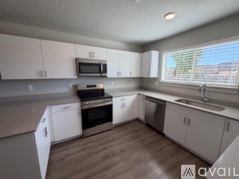 A kitchen with white cabinets and a microwave above the stove.
