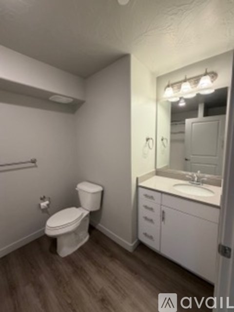 A white toilet and sink in a small bathroom.
