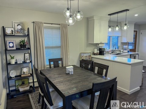 A modern dining room with a wooden table and chairs.