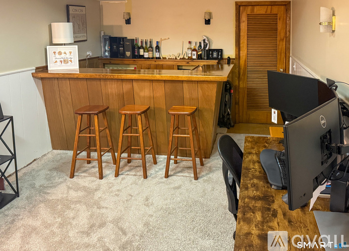 A bar area with a counter and stools.