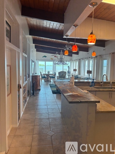 A kitchen with a long island in the middle.