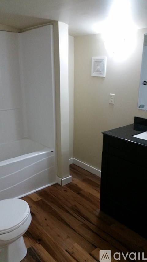 A bathroom with a toilet and a cabinet.
