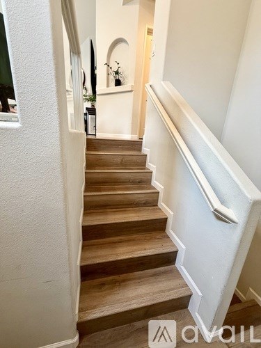 A staircase with wooden steps and white railings.