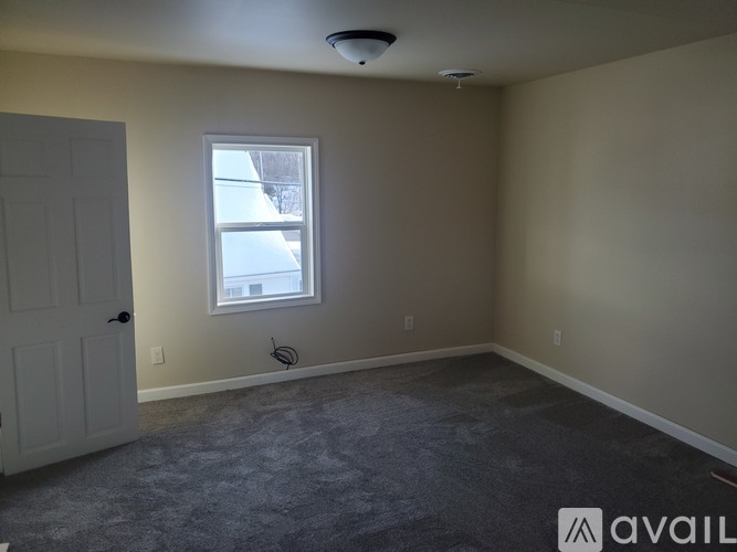 A room with a window and a door.