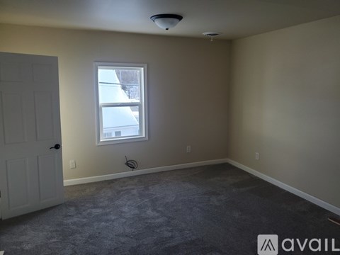 A room with a window and a door.