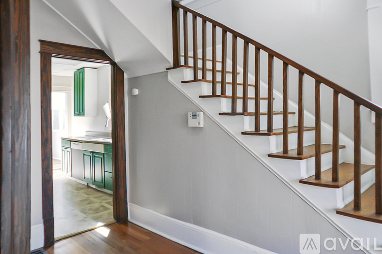 A staircase with wooden railings leads to a second floor.
