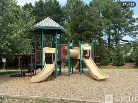 A playground with a green roof and a yellow slide.