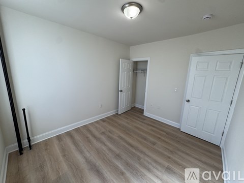 A room with a white door and a white wall.
