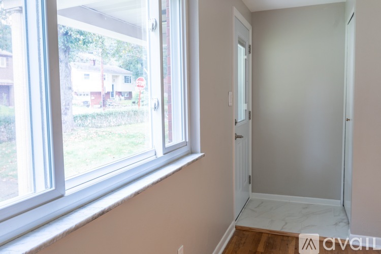 A room with a window and a door is available for rent.