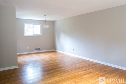 A room with wooden floors and a window.
