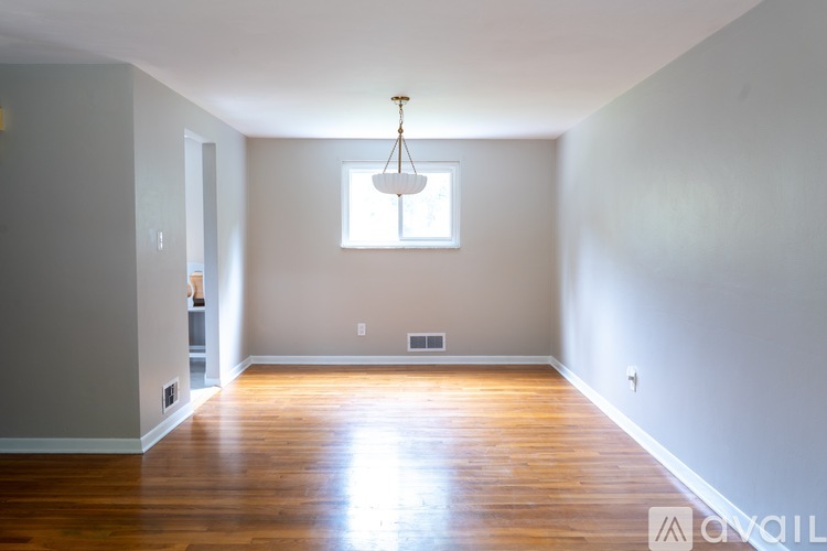 A room with wooden floors and a window.